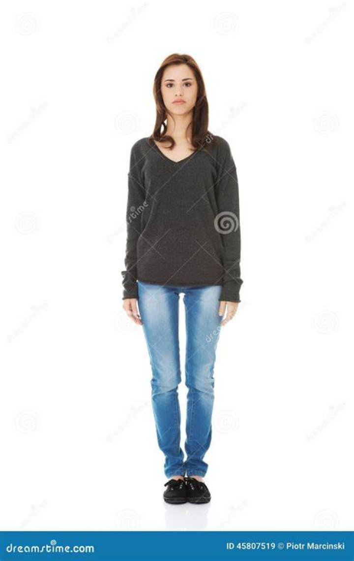 a person standing in front of a brick wall