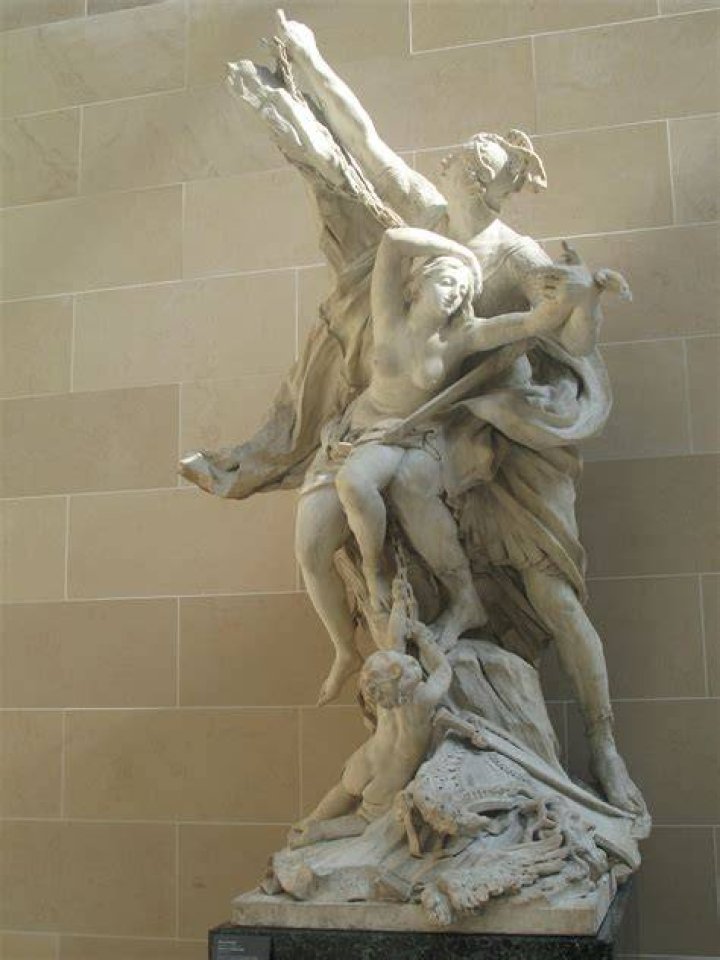 a statue of a person holding a handbag