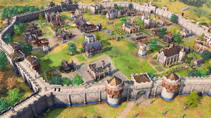 An Age of Empires 4 town surrounded by Stone Walls, Towers and Gates.