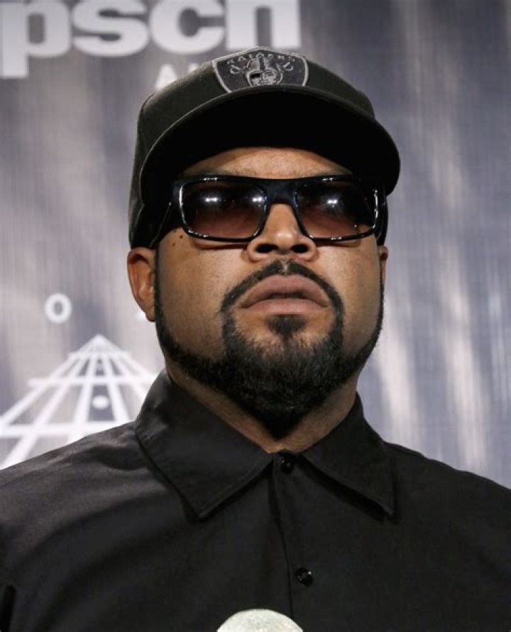 Ice Cube wears black and holds his hands to the camera as he poses in front of the Sydney Opera House