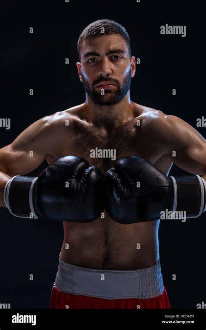 Image of a boxer posing in a boxing ring, with the Floki Inu logo as their face.