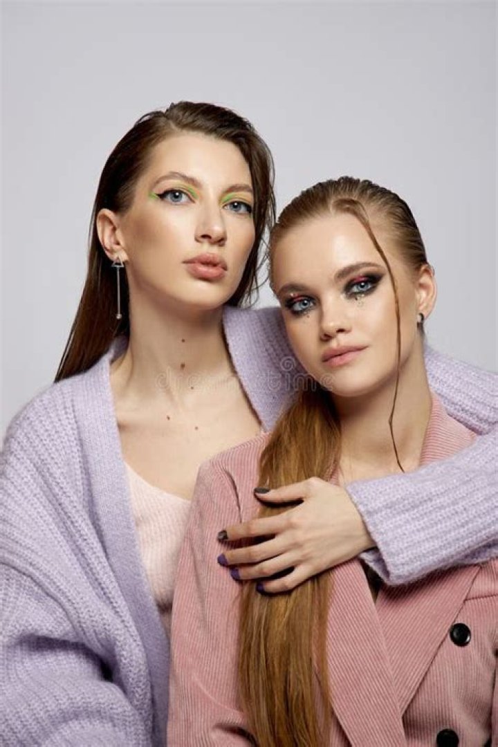 two models pose in a park